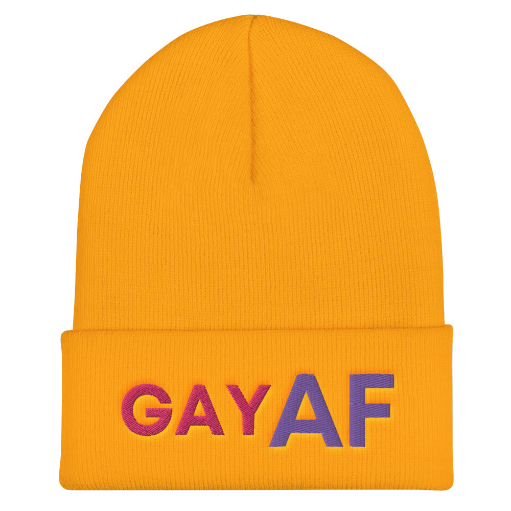 Front view of a gold cuffed beanie with multicolor “GAY AF” lettering