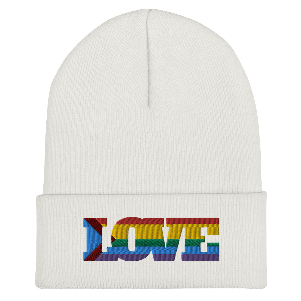 White cuffed beanie with rainbow-striped embroidered “LOVE” lettering