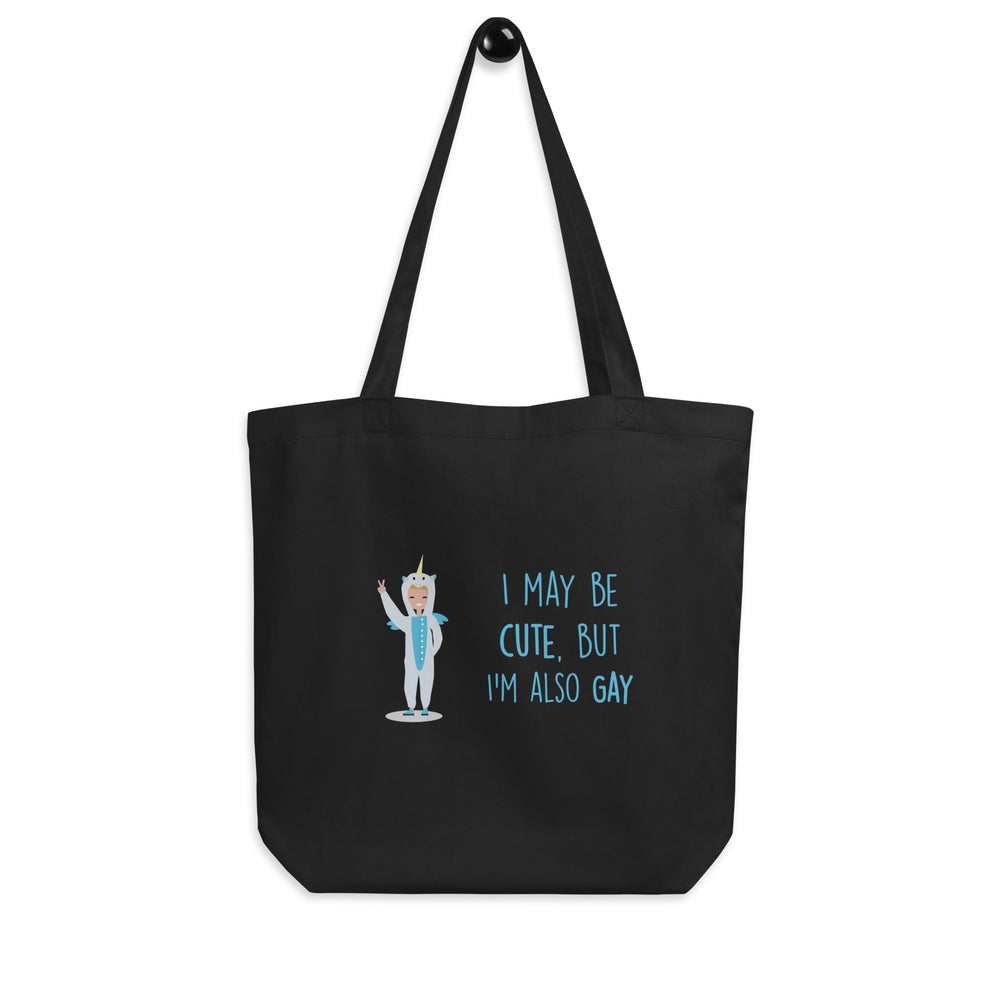 Black tote bag with a unicorn-costumed figure and the wording “I MAY BE CUTE, BUT I'M ALSO GAY”