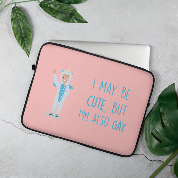 Pink laptop sleeve with a unicorn-costumed figure and “I MAY BE CUTE, BUT I’M ALSO GAY” text