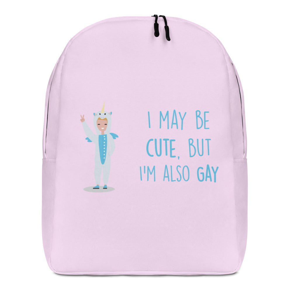 Front view of a light pink backpack reading “I MAY BE CUTE, BUT I'M ALSO GAY”