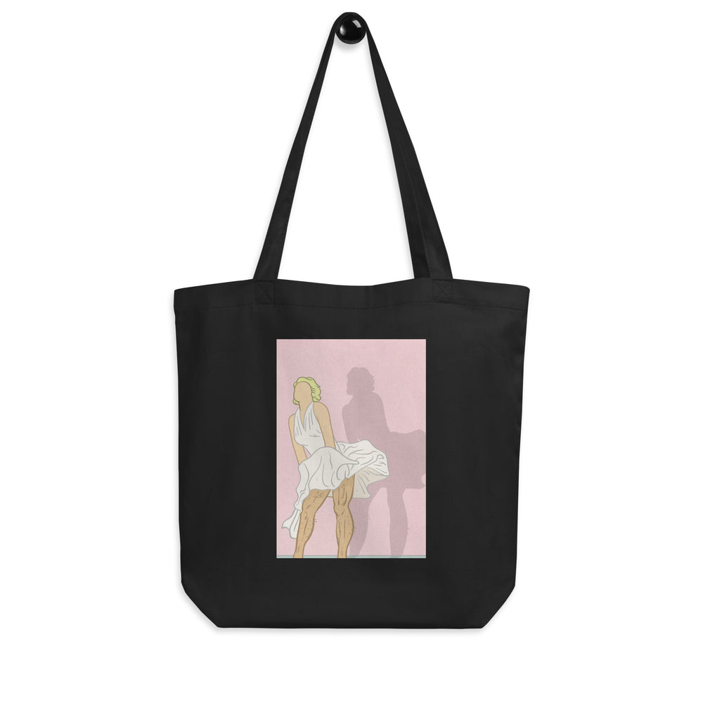Front view of a black tote bag with a vintage-style illustration of a woman in a white dress