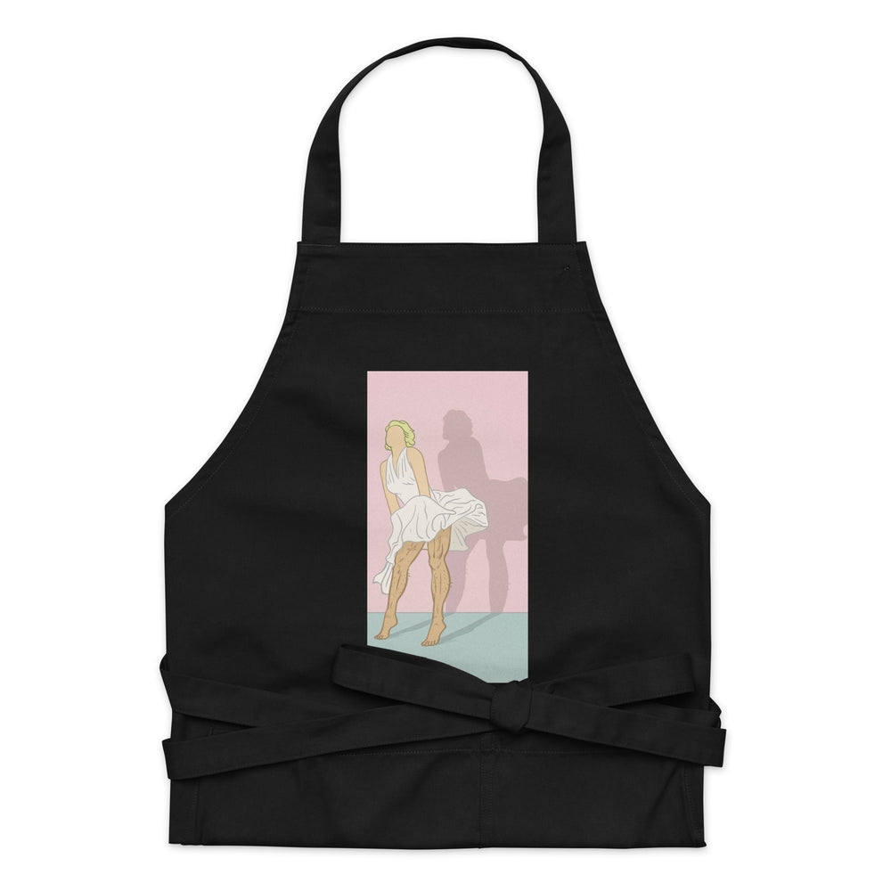 Front view of a black apron with a pink Marilyn Monroe-style skirt graphic and tied waist straps