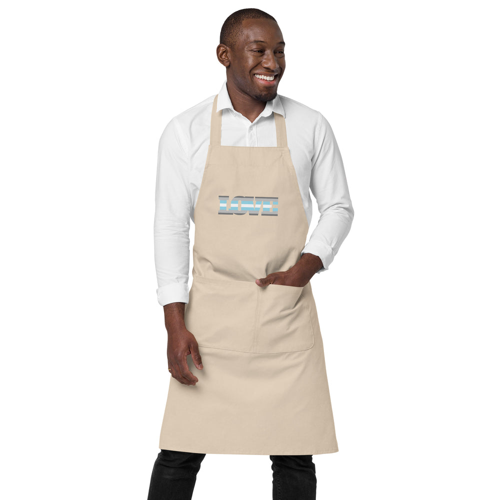 Front view of a beige apron worn over a white shirt, with a blue and gray striped chest graphic