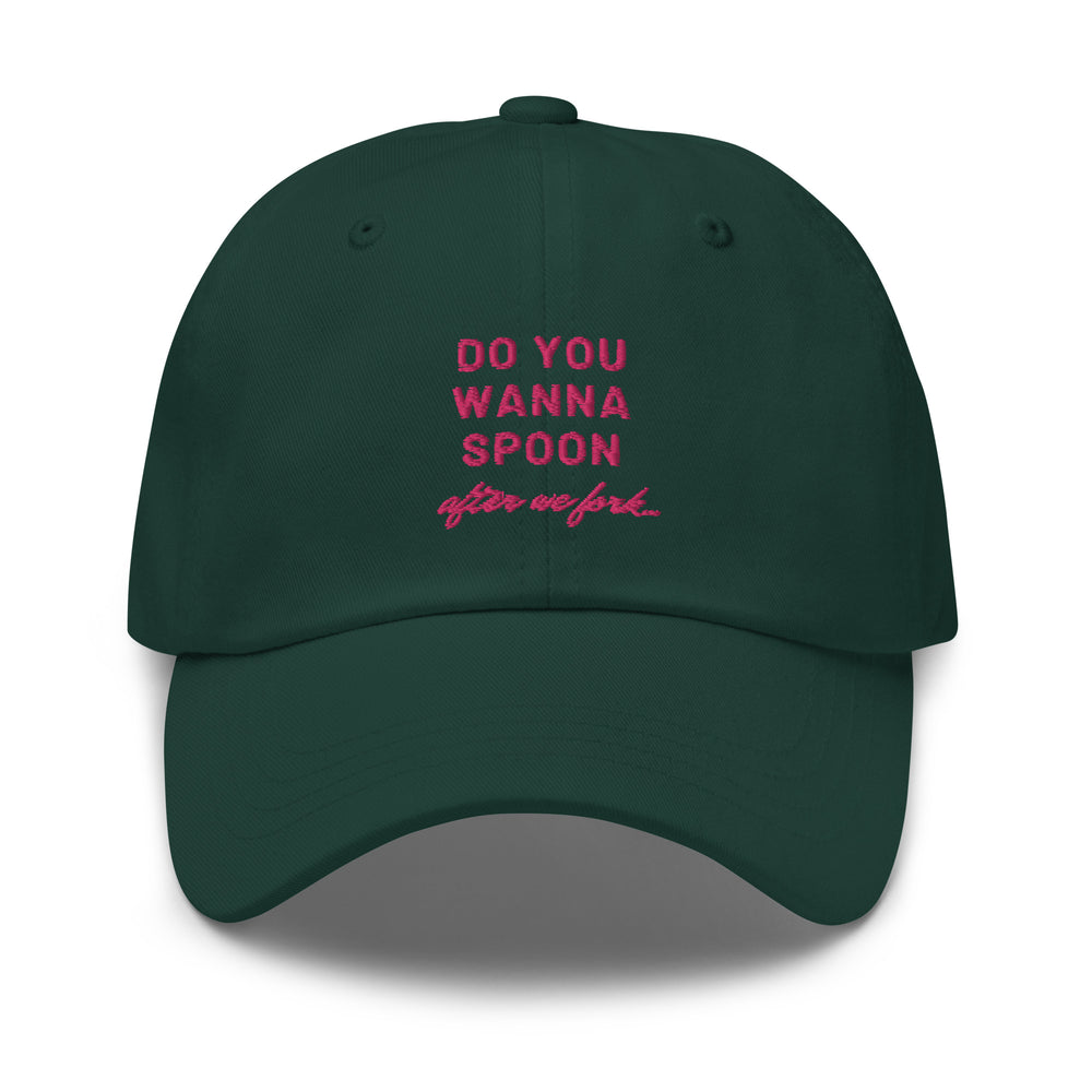 Front-facing dark green cap with pink text reading “DO YOU WANNA SPOON after we fork”