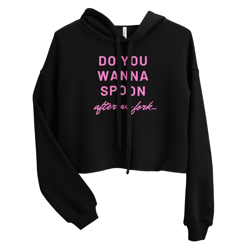 Front view of a black cropped hoodie with pink “DO YOU WANNA SPOON after we fork...” text