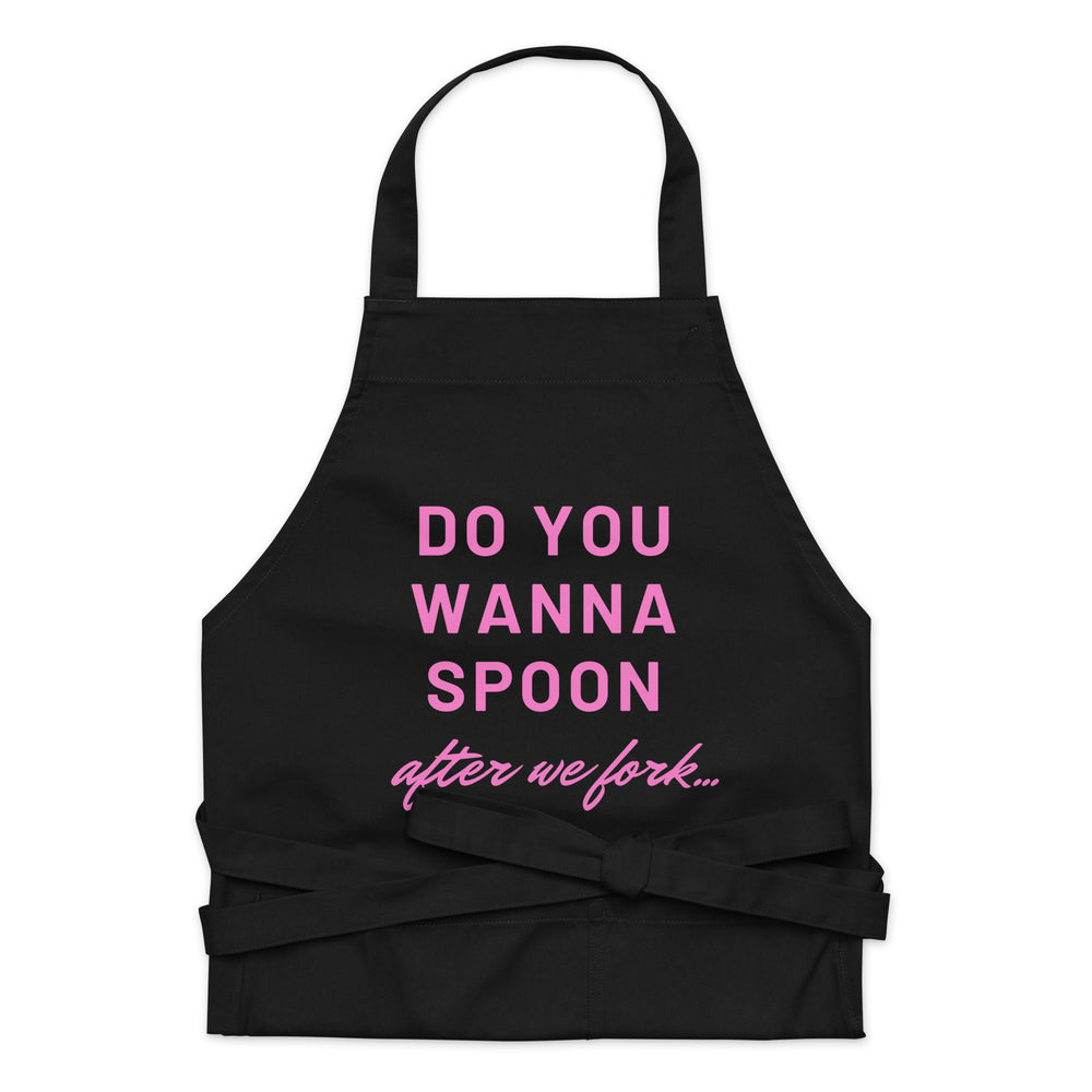 Black apron with pink text reading “DO YOU WANNA SPOON after we fork...”