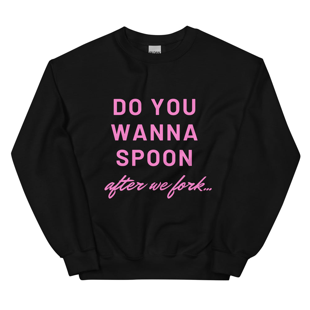Front view of a black sweatshirt with pink text, “DO YOU WANNA SPOON after we fork...”