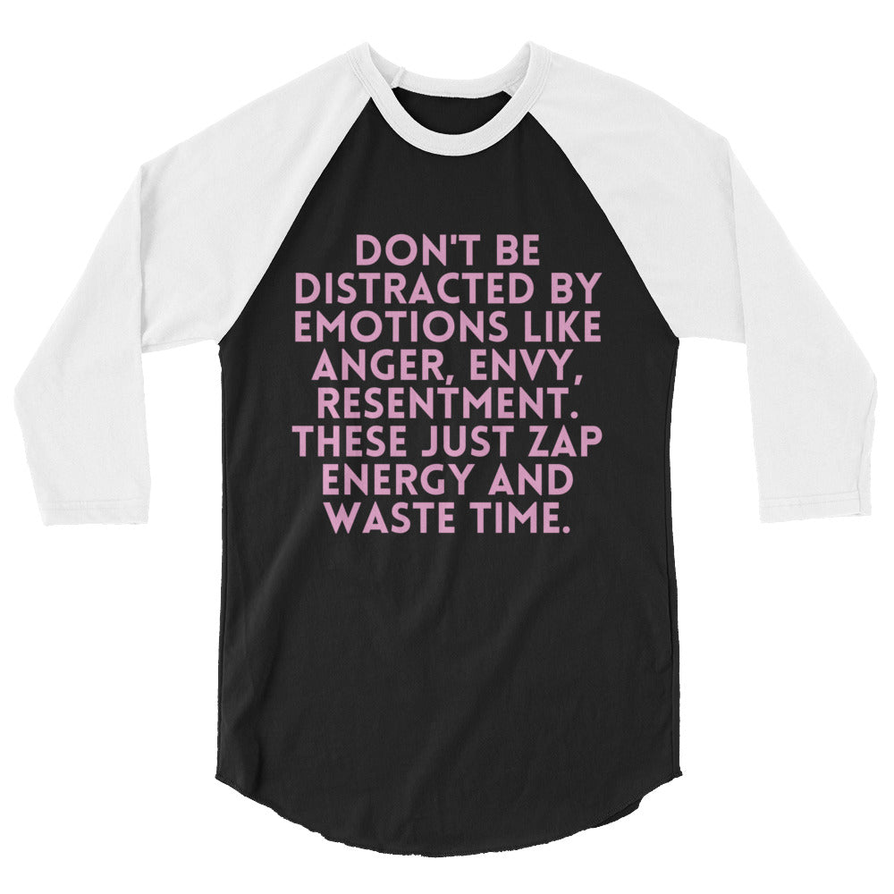 Front view of a black-and-white raglan shirt with pink text about avoiding distracting emotions