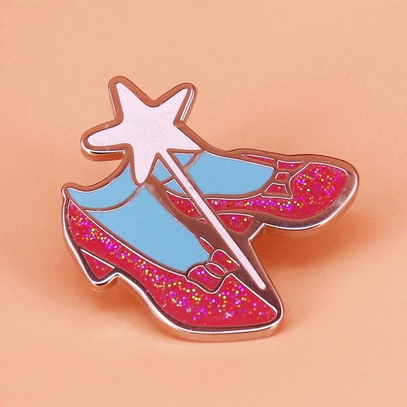 Ruby-red glitter slippers enamel pin with a white star and blue accents
