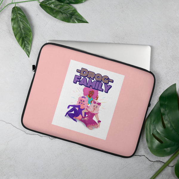 Angled pink laptop sleeve with black trim, “DRAG FAMILY” artwork, and three illustrated drag queens