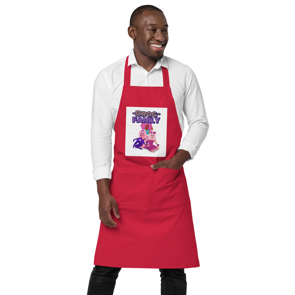 Front view of a person wearing a red apron with a “DRAG FAMILY” graphic and front pocket