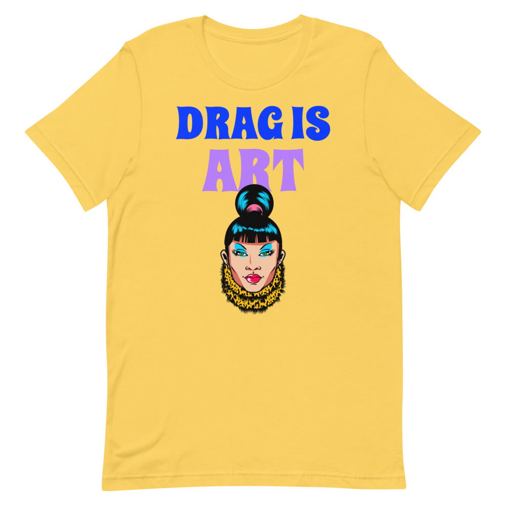 Yellow T-shirt with “DRAG IS ART” lettering and a colorful drag performer illustration