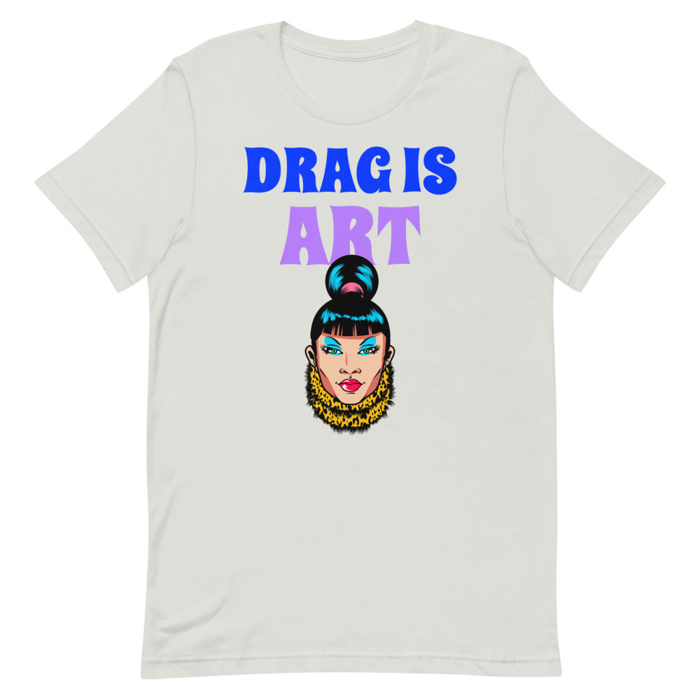 White T-shirt with “DRAG IS ART” lettering and a colorful illustrated drag queen face