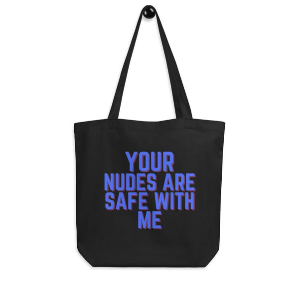 Black tote bag printed with “YOUR NUDES ARE SAFE WITH ME” in blue and red lettering