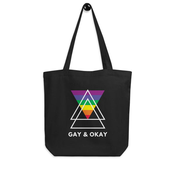 Black tote bag with rainbow triangle graphic and “GAY & OKAY” text