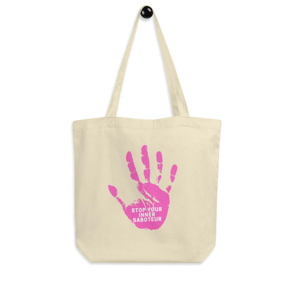 Cream canvas tote bag with a pink handprint and “STOP YOUR INNER SABOTEUR” text