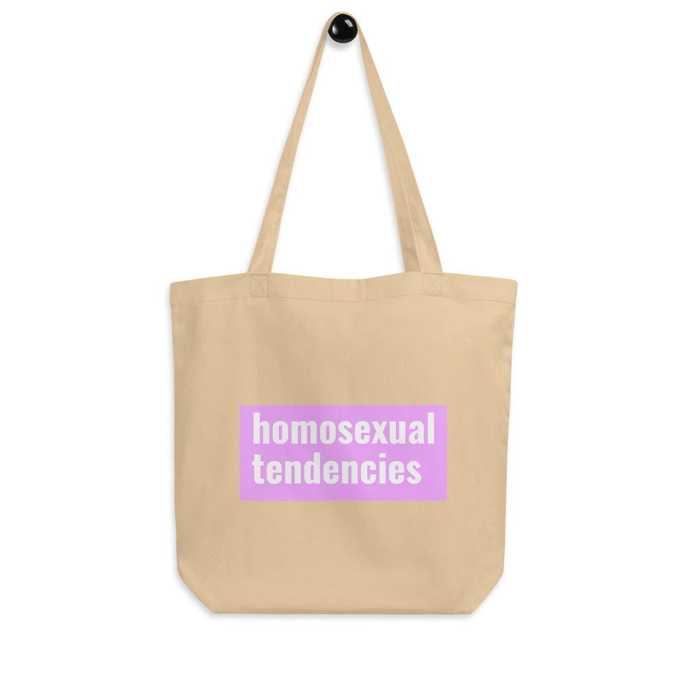 Front-facing beige tote bag with a pink panel reading “homosexual tendencies”