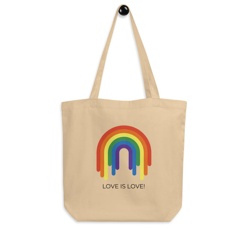 Front-facing beige tote bag with a rainbow arch and the words “LOVE IS LOVE!”