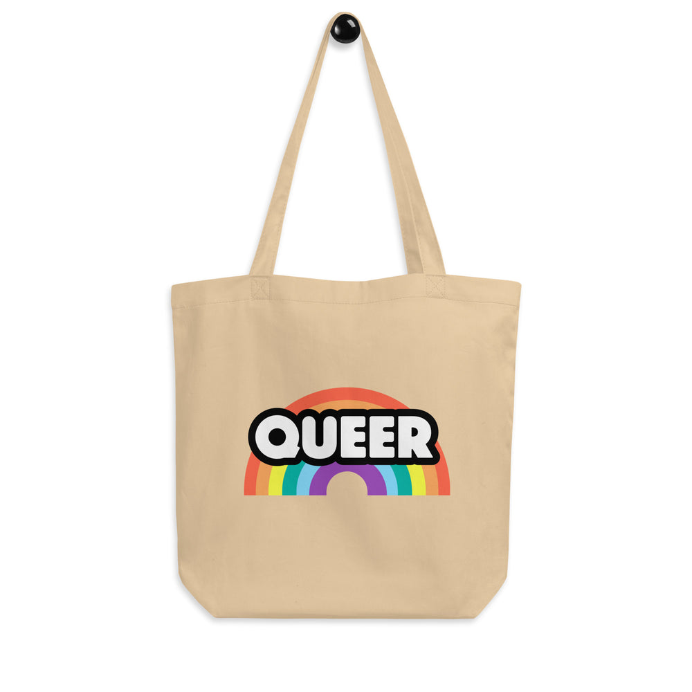 Front-facing beige tote bag with long handles, rainbow graphic, and bold “QUEER” lettering