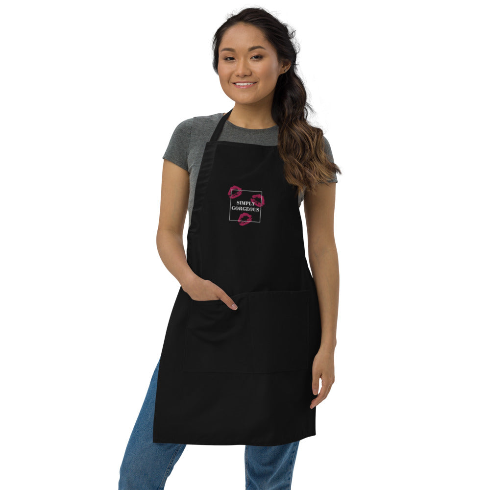 Front-facing model wearing a black apron with pink lips and “SIMPLY GORGEOUS” design
