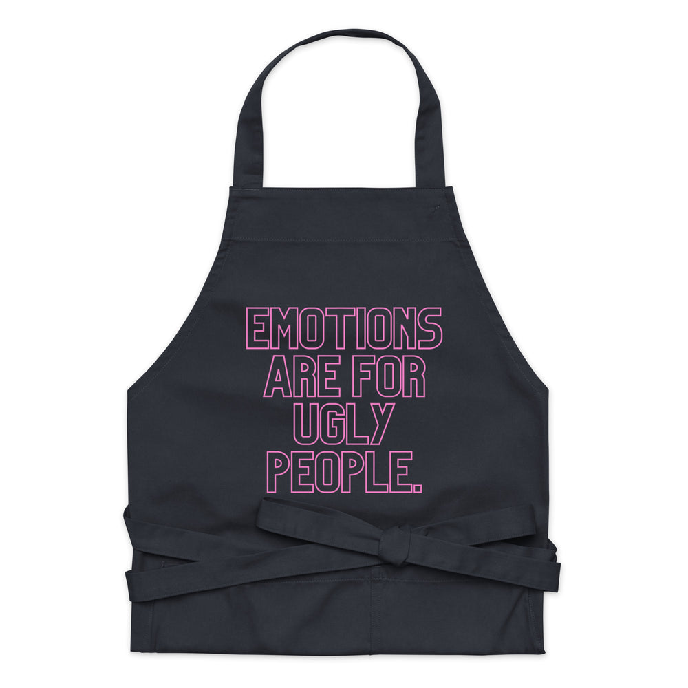 Front-facing black apron with pink outlined text reading “EMOTIONS ARE FOR UGLY PEOPLE.”