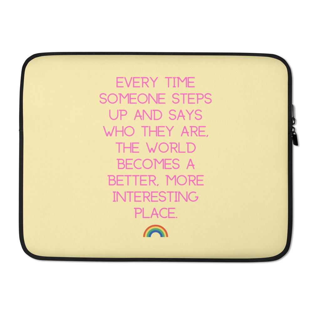 Front-facing cream laptop sleeve with pink text and a small rainbow graphic
