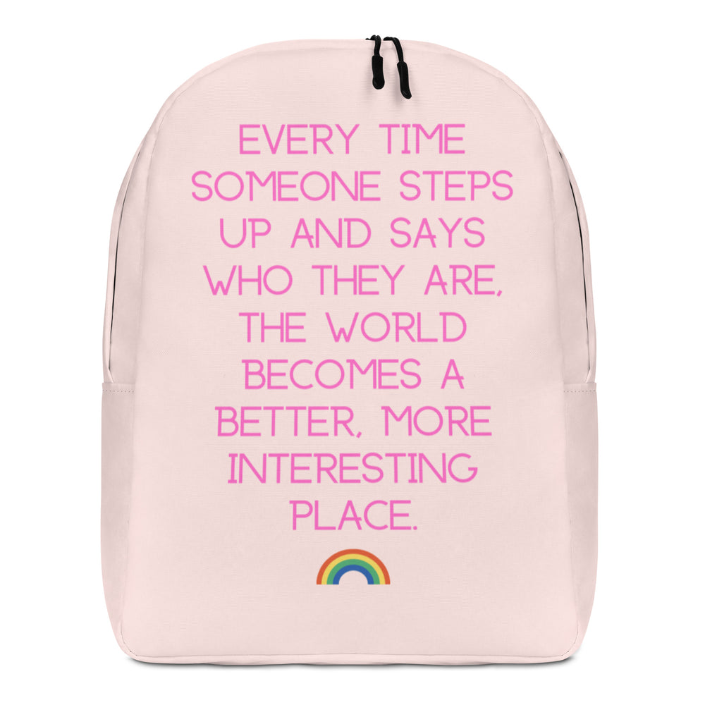 Front-facing pale pink backpack with bright pink quote text and a small rainbow graphic