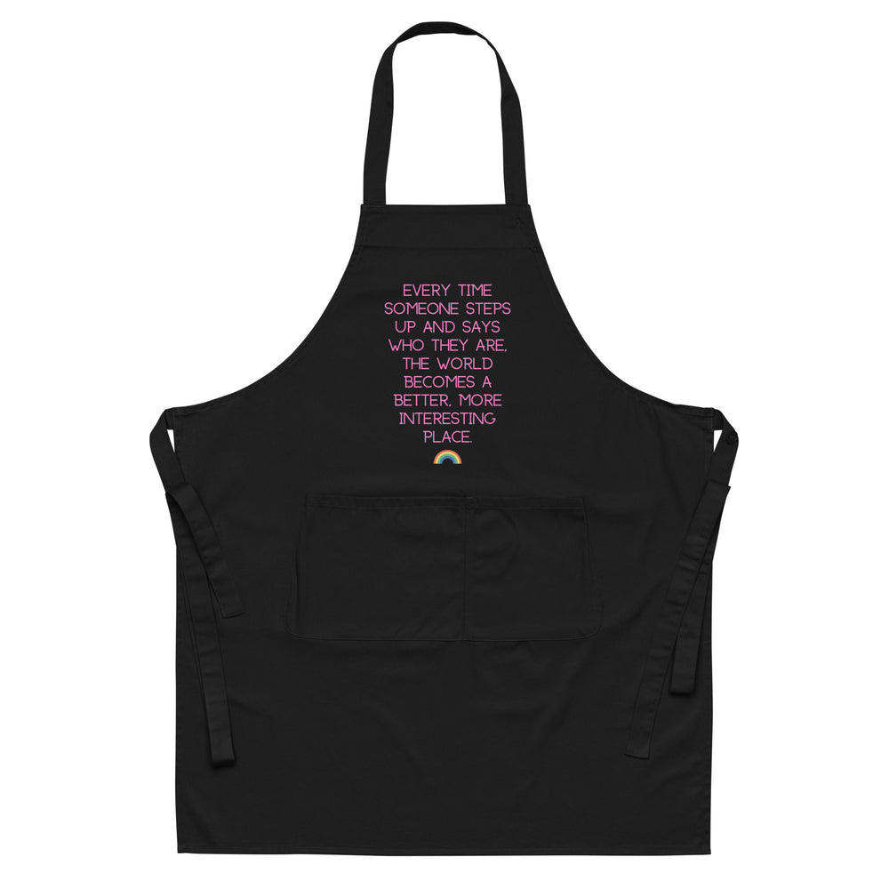 Front view of a black apron with pink text and a small rainbow above a large pocket