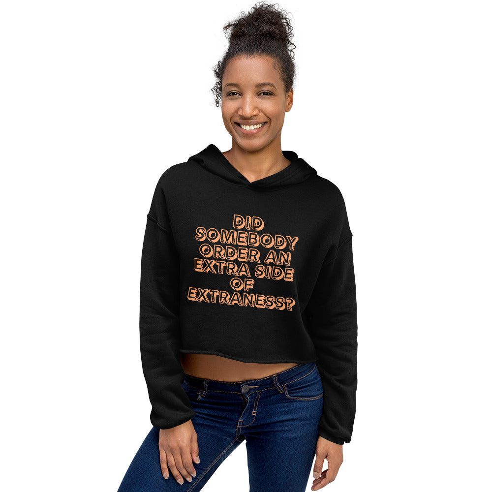 Model wearing a black cropped hoodie with orange text reading “Did somebody order an extra side of extraness?”