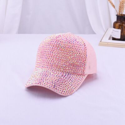 Pink rhinestone baseball cap displayed on a white surface