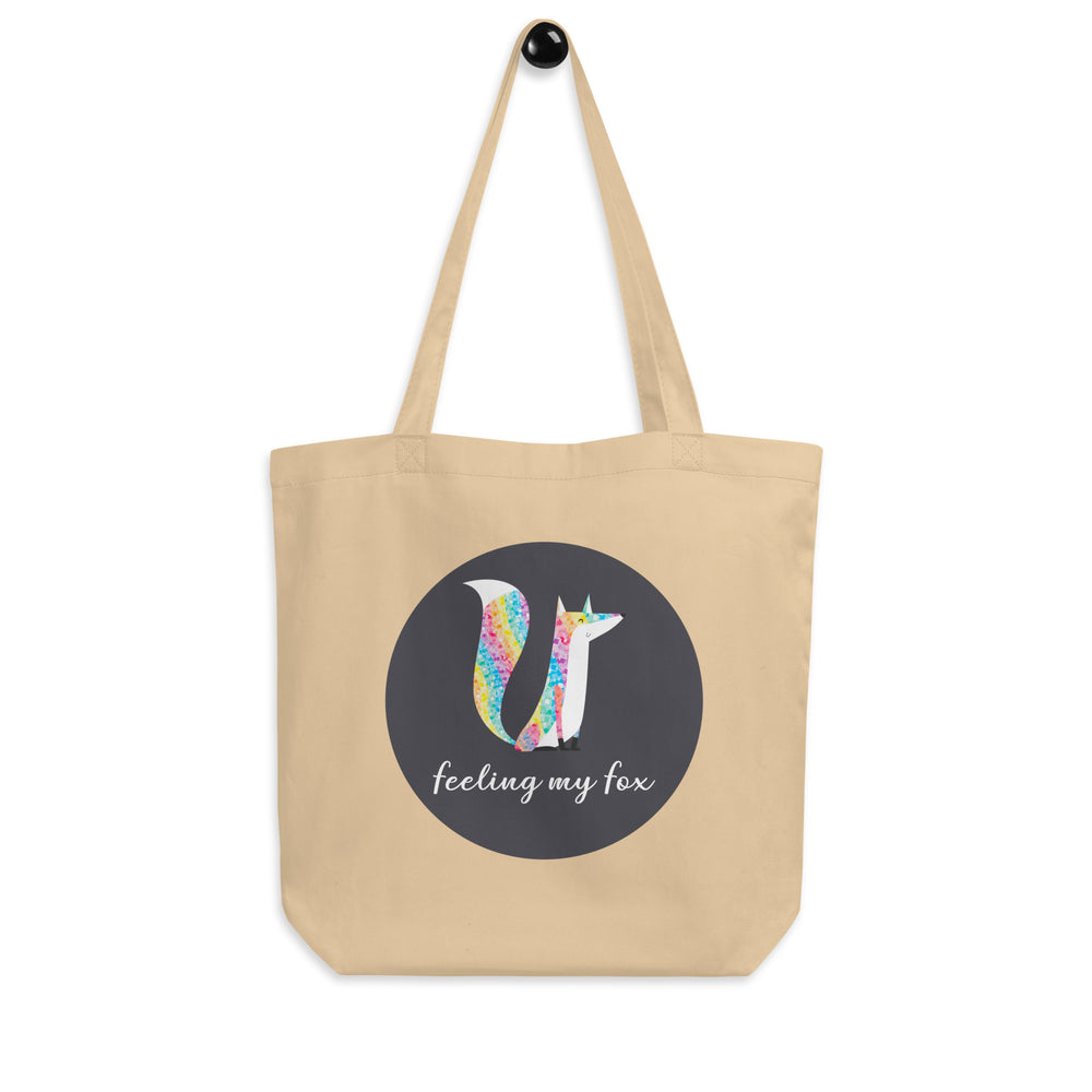 Front view of a natural canvas tote with a colorful fox and “feeling my fox” text