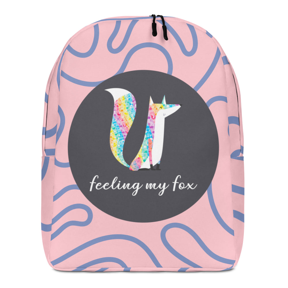 Front view of a pink backpack with blue squiggles, a rainbow fox, and “feeling my fox” text