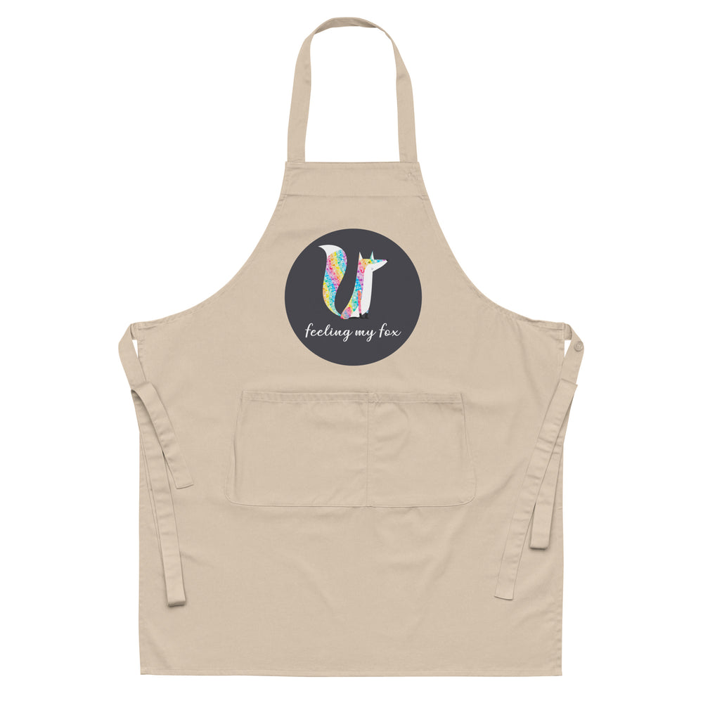 Front-facing beige apron with a colorful fox graphic and “feeling my fox” text