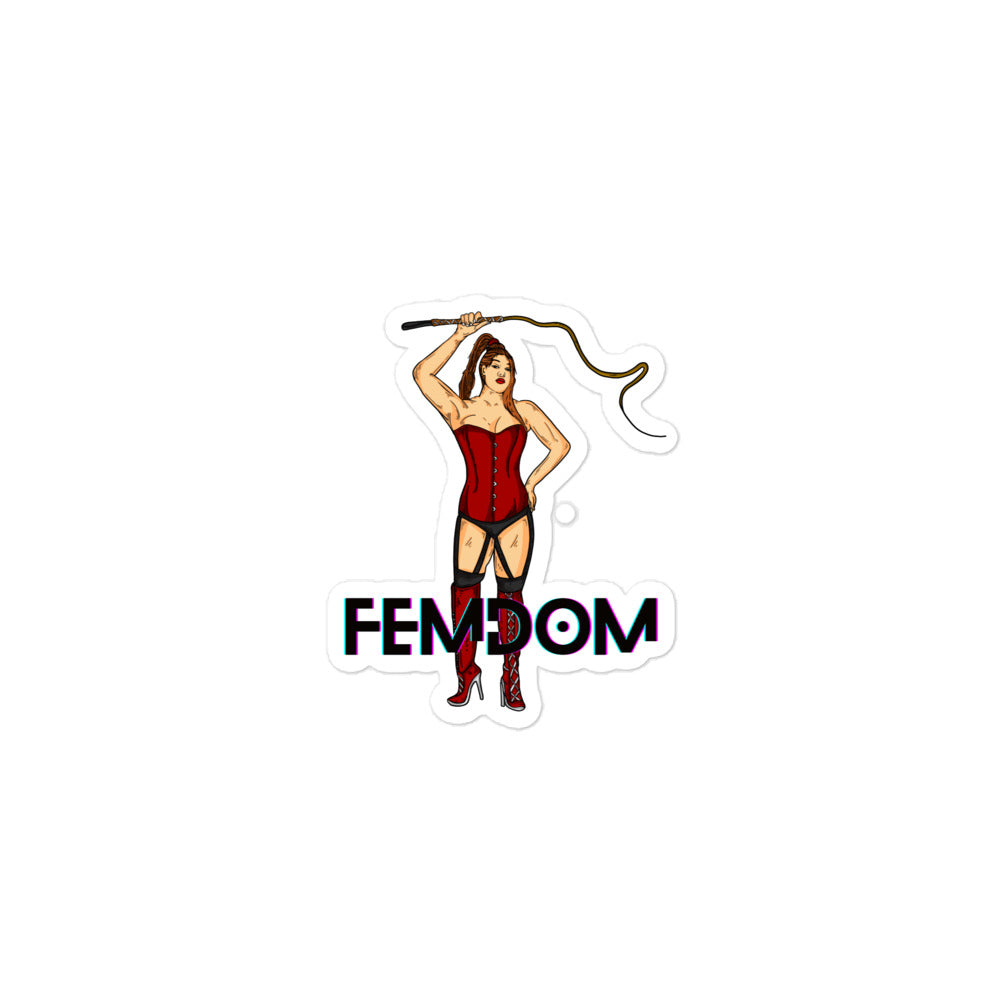 Sticker showing a woman in red corset and thigh-high boots holding a whip above “FEMDOM”