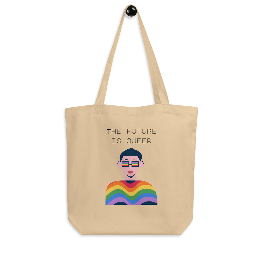 Front view of a beige tote bag reading “THE FUTURE IS QUEER,” with a rainbow illustration.
