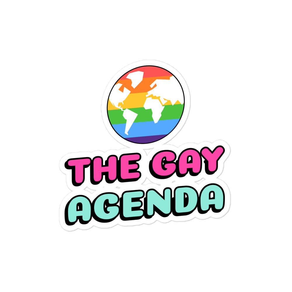 Sticker reading “THE GAY AGENDA” beneath a rainbow-striped globe graphic