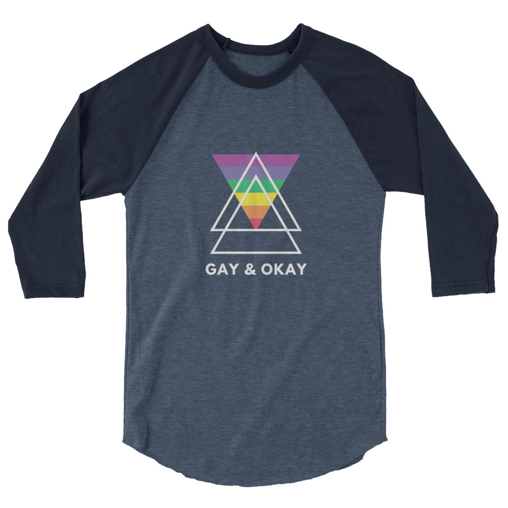 Front view of a charcoal and navy raglan shirt reading “GAY & OKAY” with a rainbow triangle graphic