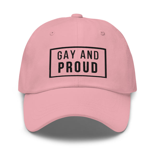 Pink dad hat with “GAY AND PROUD” in bold black, embroidered on front. Neon 3D rainbow tunnel and glowing rainbow light underneath.