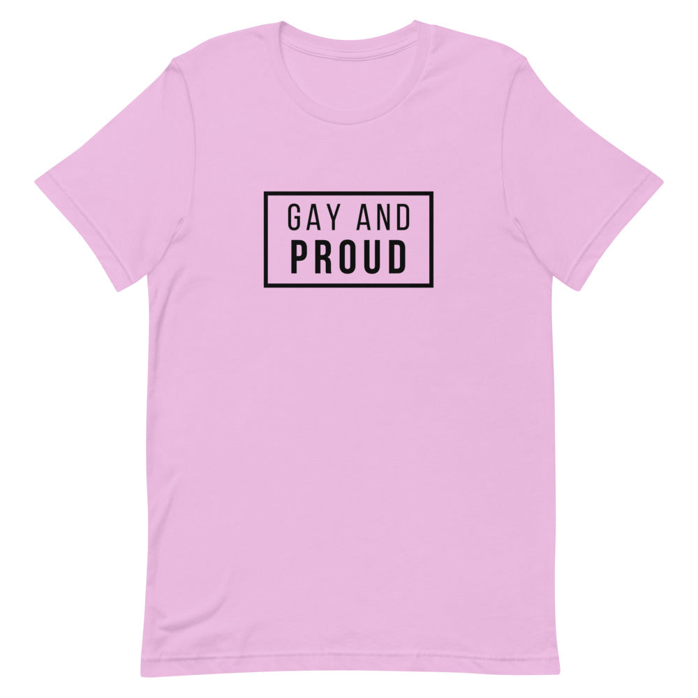 Pink T-shirt with a black outlined rectangle reading “GAY AND PROUD”