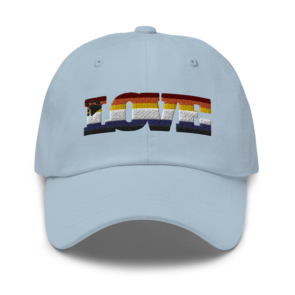 Front view of a light blue cap with embroidered rainbow-striped “LOVE” lettering and bear motif