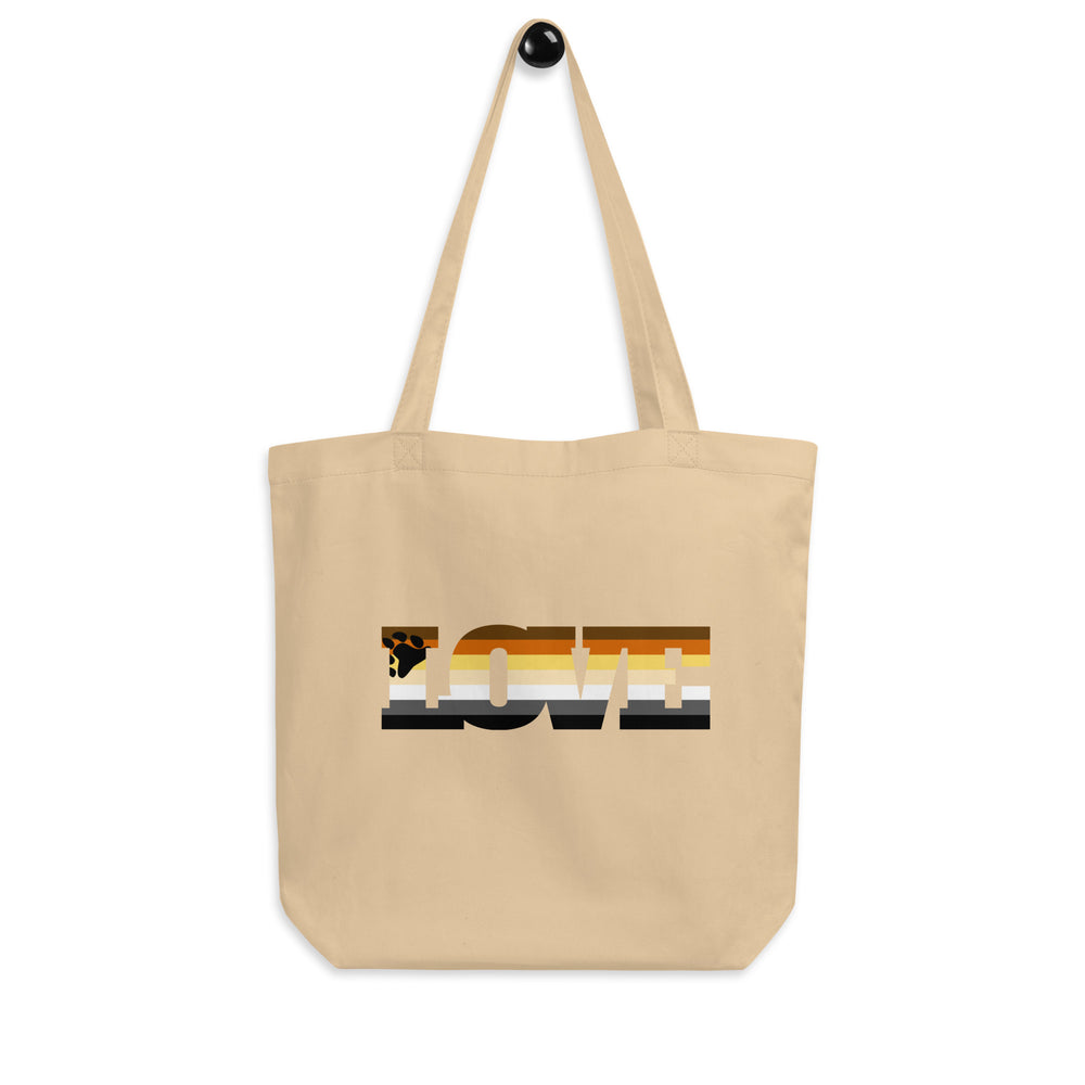 Front-facing beige tote bag with long handles and a multicolored bear-themed graphic