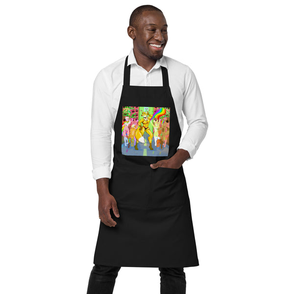 Front view of a black apron with a colorful furry character and rainbow design, modeled over a white shirt