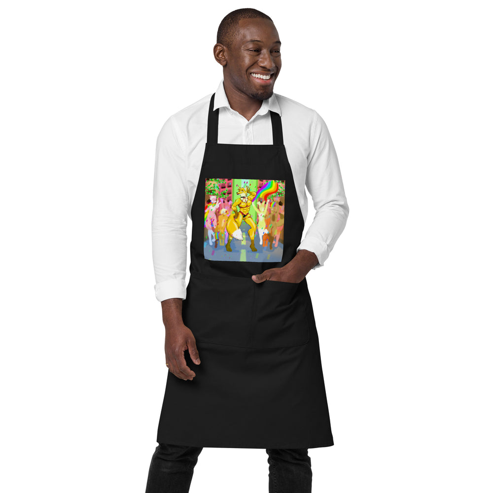 Front view of a black apron with a colorful furry character and rainbow design, modeled over a white shirt