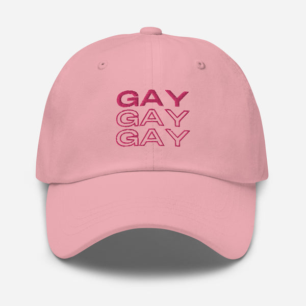 Front view of a pink baseball cap embroidered with “GAY” three times