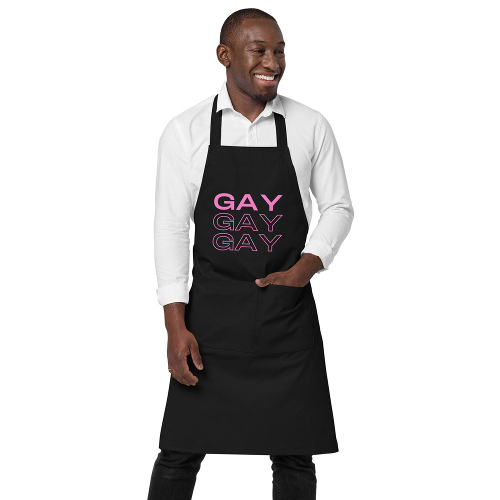 Front view of a person wearing a black apron reading “GAY GAY GAY” in pink lettering.