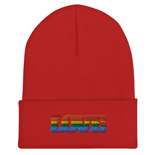 Front view of a red cuffed beanie embroidered with rainbow-striped LOVE lettering