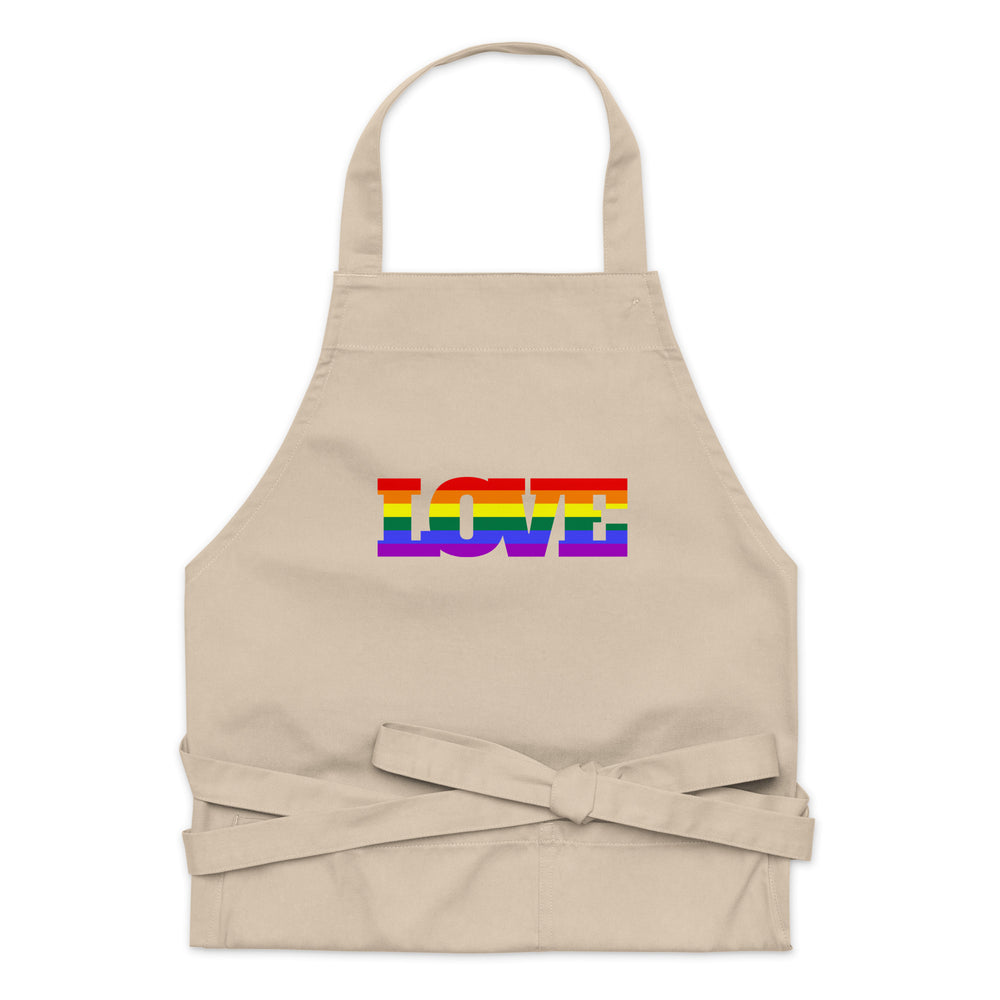 Front-facing beige apron with rainbow-striped “LOVE” lettering and waist ties