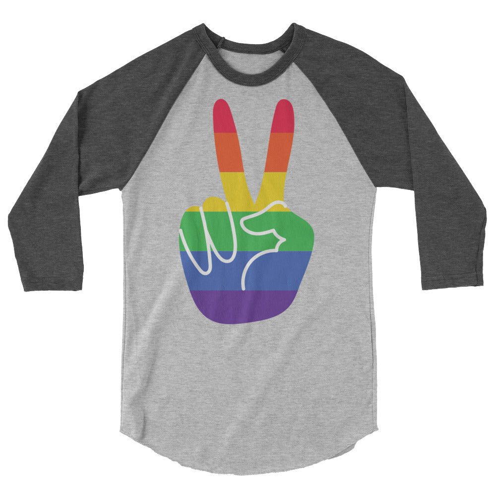 Gay Pride 3/4 Sleeve Raglan Shirt in gray and charcoal, flaunting a rainbow-striped peace hand symbol, worn at a queer art gallery.