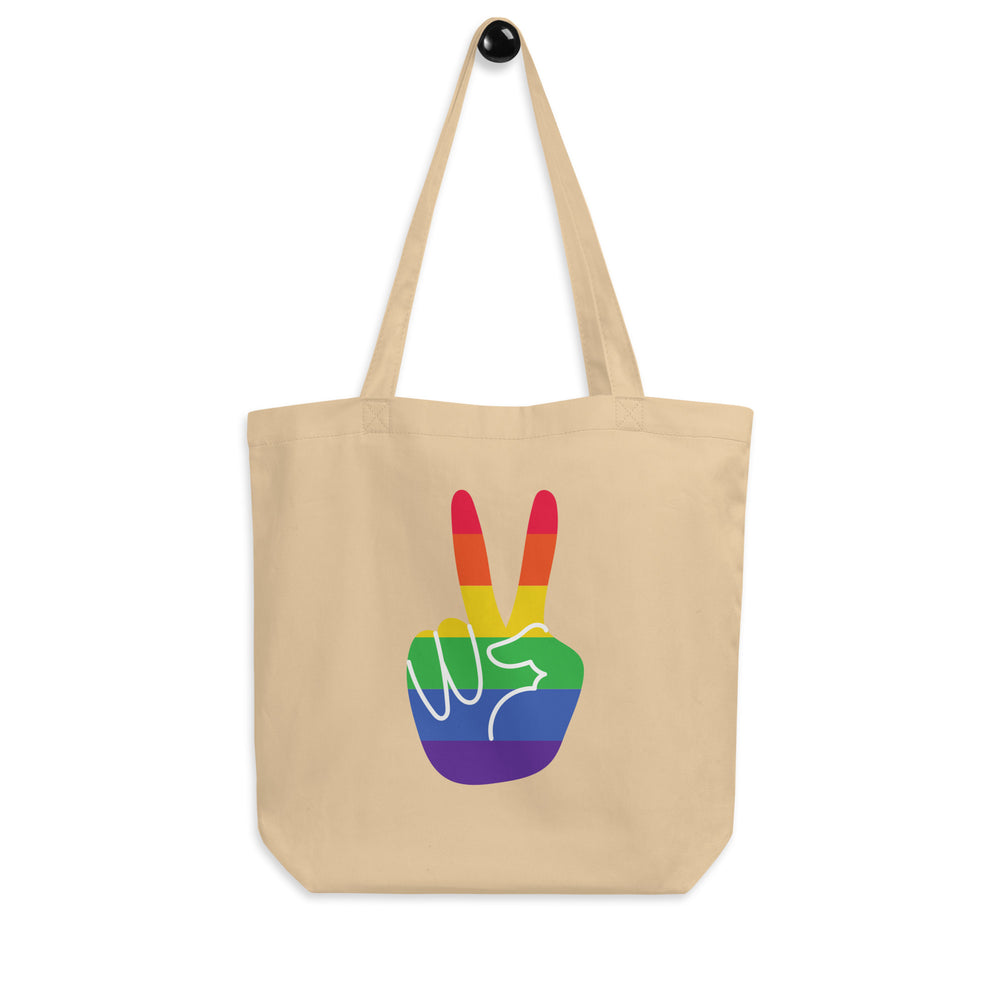 Front view of a natural canvas tote with a rainbow peace-sign hand graphic